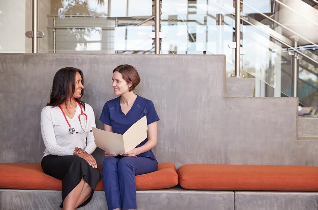 two female healthcare workers discussing a medical sf9rjn8